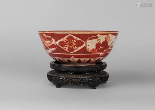 A Japanese earthenware bowl, early 20th century, painted with panels depicting figures, a phoenix, and a landscape, 20.5cm diameter, on Chinese hardwood stand (2)