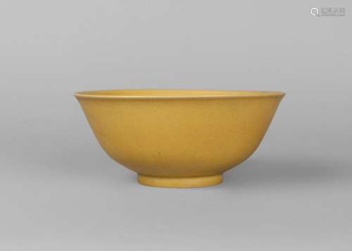 A Chinese porcelain monochrome bowl, Qianlong mark, 20th century, of ogee form, with allover pale yellow glaze, white glazed base, paper collection label to base, 17.5cm diameter, 7cm high