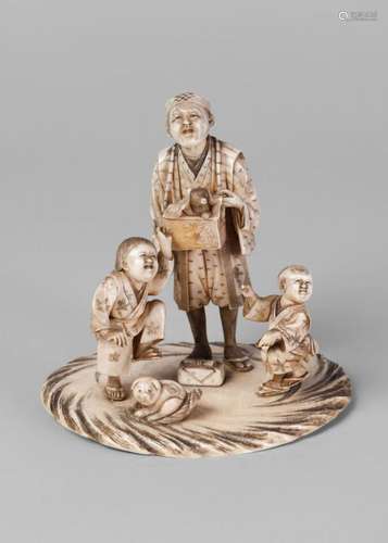 A Japanese ivory figure group, late 19th century, carved as a man holding a box with an animal, beside two children and a puppy, 11cm high