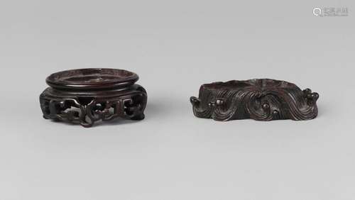 Two Chinese carved hardwood stands, 18th/19th century, one finely carved with crashing waves, the other pierced with archaistic motifs, 7cm wide (2)