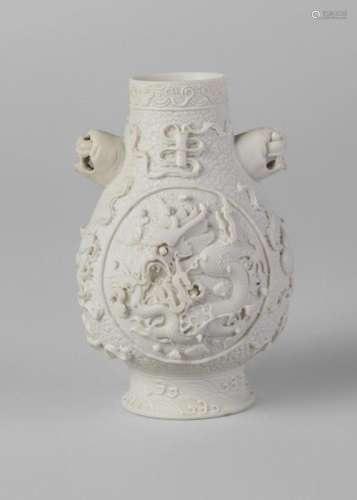 A Chinese biscuit porcelain 'Eight Taoist Emblems' miniature vase, impressed Qianlong mark but 19th century, finely carved with two circular panels of dragons amidst flames and clouds on a ground decorated with with the 'Eight Emblems of the Taoist Immortals' above a band of crashing waves to the foot, with Buddhist lion mask handles, 10cm high Provenance: Private UK Collection