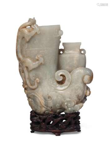A Chinese pale celadon jade rhyton, 18th century, finely carved to the main section with a chilong dragon to the rim, with russet surface, a phoenix standing on cloud wisps holding a lingzhi sprig in its mouth, beside a twin handled vase, overall carved in low relief with archaistic motifs, 17cm high, on carved hardwood stand