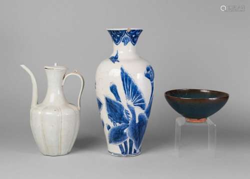 A Chinese Song style qingbai ewer and cover, 20th century, with loop handle, the body of lobed form, 26cm high, a Chinese junyao style purple splash bowl, 20th/21st century, 18.5cm diameter, and a blue and white decorated vase, 37cm high (3)