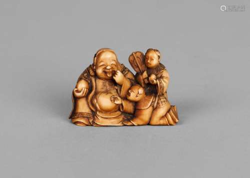 A Japanese ivory Hotei netsuke, early 20th century, carved as Hotei with two boys, 4.2cm wide