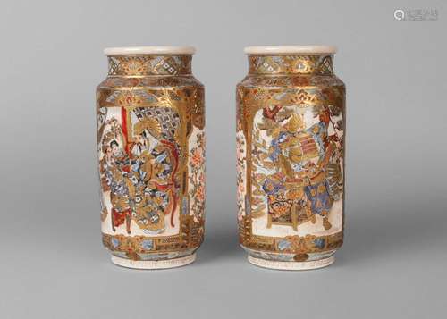 A pair of Japanese Satsuma cylindrical vases, early 20th century, decorated with panels depicting an emperor and attendants, on a ground of floral motifs, 24.5cm high