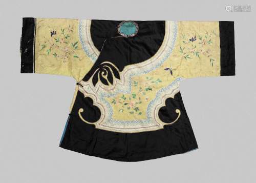 A Chinese silk embroidered jacket, late Qing dynasty, the sleeves and body decorated with birds in flight amidst blossoming chrysanthemum and prunus on a yellow ground