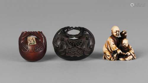 Three Japanese netsuke, 19th-20th century, one ivory carved as a kneeling man with his son, 3.5cm high, two wood carved as bells, (3)