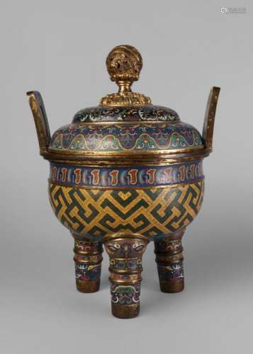 A large Chinese gilt metal and cloisonne archaistic censer and cover, Qianlong mark and period, the cover with pierced spherical finial decorated with a dragon amidst clouds, above two domed sections decorated with stylised tao-tie masks on a black ground, and floral scrolls on a blue ground, the body decorated with geometric motifs on a yellow ground, with rectangular handles and on three cylindrical feet, 39cm high, 28cm wide