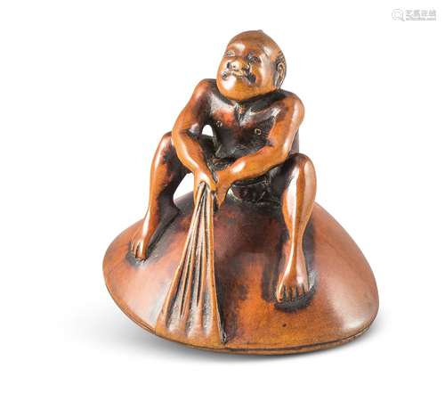 NETSUKE: BAUER AUF MUSCHEL. Japan. Edo-Zeit. Frühes 19. Jh. Buchsbaum mit fein geschnitzten