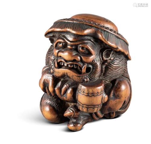 NETSUKE: ONI. Japan. Edo-Zeit. Mitte 18. Jh. Muskulöser Oni, hockend mit entschlossenem