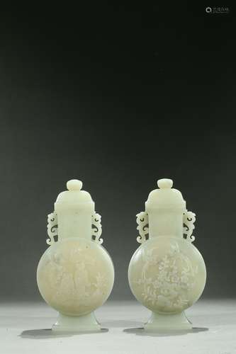 A pair of celadon jade 'figures and birds' moonflasks