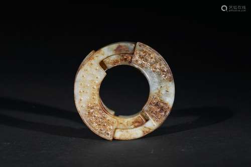 A white and russet jade ring carving