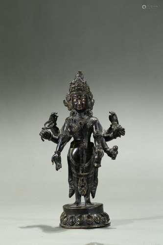 A bronze figure of six-armed bodhisattva
