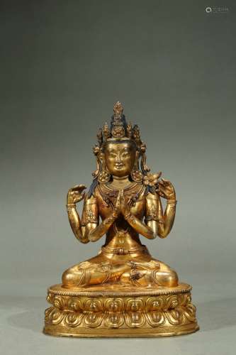 A gilt-bronze figure of four-armed bodhisattva