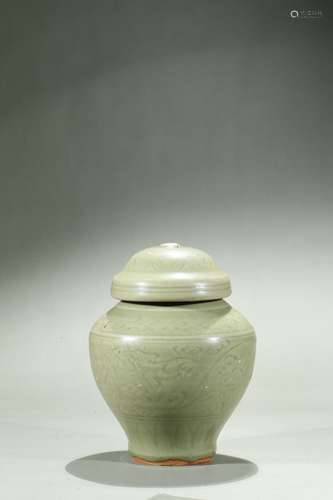 A celadon carved jar and cover