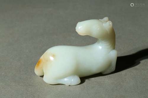 A white jade carved recumbent horse