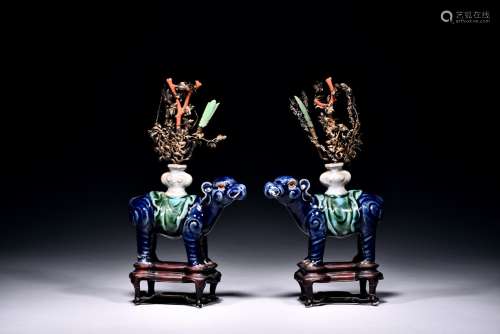A pair of blue glazed mythical beast supporting vases