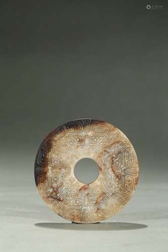 An archaic russet jade taotie disc bi