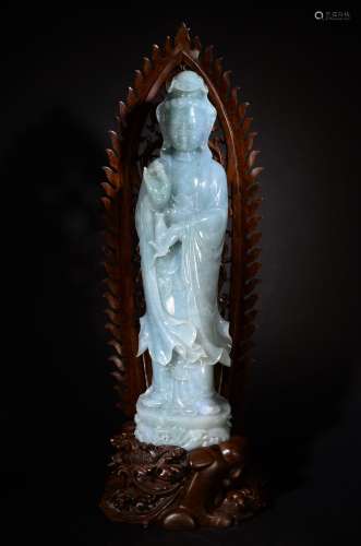 A JADE CARVED FIGURE OF GUANYIN AND WOODEN STAND