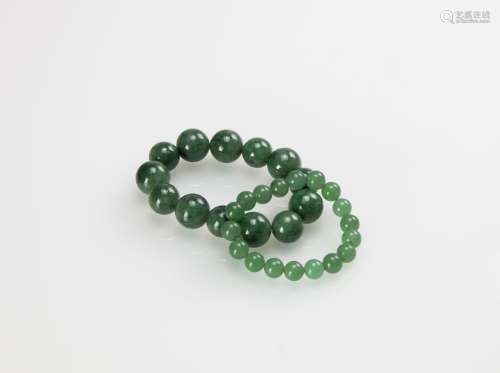 A Group of Two Jade Bracelets