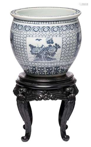 A Chinese blue and white decorated jardiniere with floral motifs, the roundels with garden scenes, birds, butterflies and flower branches, on a matching sculptured black lacquered wooden soccle, H 49,5 cm (without base) - 100 cm (with base)