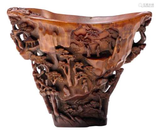 An extraordinary finely carved rhinoceros horn libation cup, the flaring sides finely carved in partial openwork with scholars strolling underneath trees in a rocky landscape and a fishing boat by the shore, a large rock to the inside upon which grows a pine tree, the flat base carved with stylised waves, 17th/18thC, H 11,5 - B 15 - D 10,5 cm - Weight: 467g, Provenance: European private collection, acquired in the 1960's in Europe and thence by descent. Literature: Compare: T. Fok, Connoisseurship in Rhinoceros Horn Carving in China, Hong Kong, 1999, p. 198, no. 142 and p. 221, no. 162