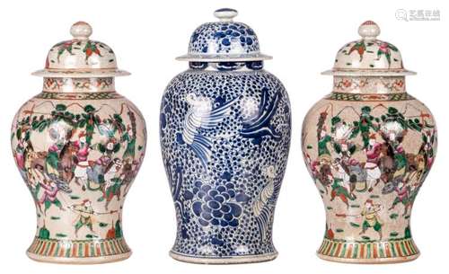 A pair of Chinese stoneware vases and covers, overall polychrome decorated with warrior scenes, marked; added a Chinese blue and white overall decorated vase and cover with phoenix and flower branches, 19thC, H 46 - 48 cm