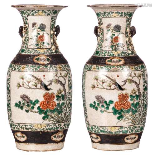 Two Chinese famille verte floral and relief decorated stoneware vases, the roundels with birds on flower branches, marked, about 1900, H 45 cm