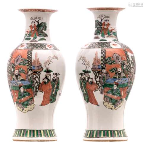 A pair of Chinese famille verte baluster shaped vases, decorated with an animated court scene, H 47 cm