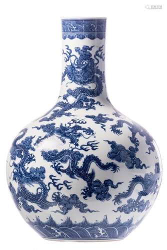 A Chinese blue and white overall decorated bottle vase with dragons playing with a flaming pearl, with a Qianlong mark, H 50,5 cm