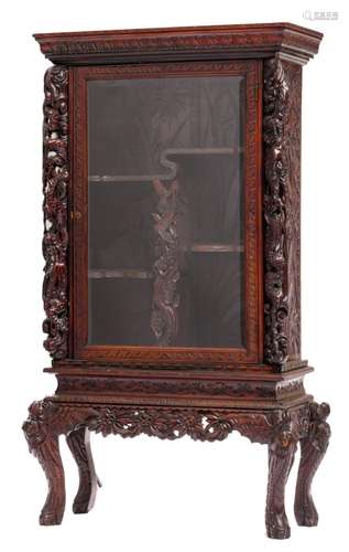 An Oriental richly carved exotic hardwood display cabinet on stand, H 117 - 172 cm