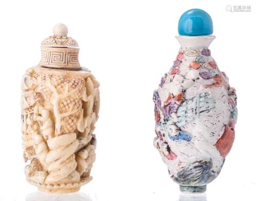 A Chinese carved ivory snuff bottle, with traces of polychromy, depicting an animated scene; added a ditto polychrome and gilt decorated relief moulded porcelain snuff bottle, about 1900, H 8 - 9 cm