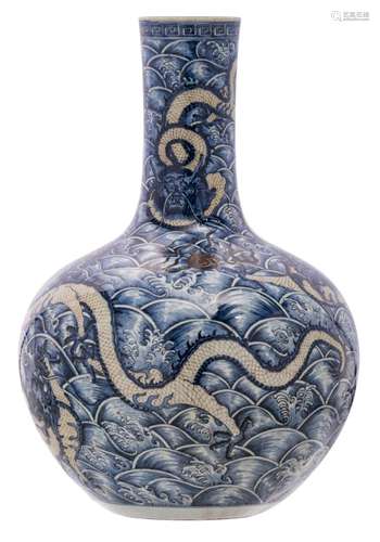 A Chinese underglaze blue and copper red bottle vase, decorated with sea dragons and a flaming pearl, with a Qianlong mark, H 59 cm