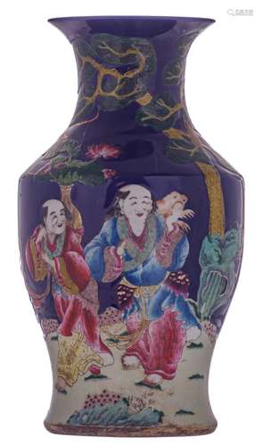 A Chinese blue ground polychrome and relief decorated vase depicting an Immortal and Liu Hai and the tree-legged toad, with a Qianlong mark, H 53,5 cm