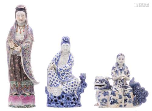 Two Chinese blue and white and famille rose decorated Guanyin figures and a ditto seated deity on a Fu lion, one Guanyin figure marked, H 25 - 47 - W 12  - 25 - D 10 - 14 cm