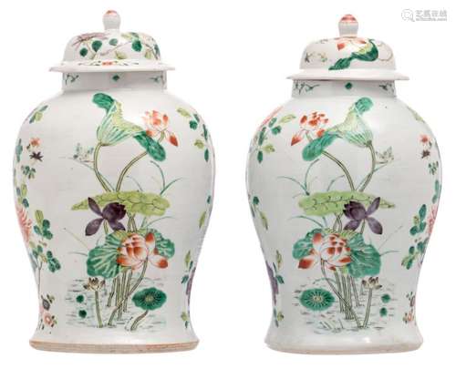 A pair of Chinese famille verte decorated vases and covers with various flower branches, H 42 cm