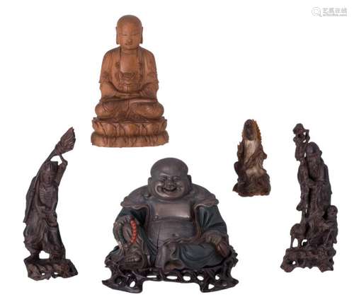 Four Chinese carved wooden figures, depicting a Buddha, a Budaï and two Immortals, one with polychromy; added a ditto horn Guanyin figure, H 8 - 16 cm