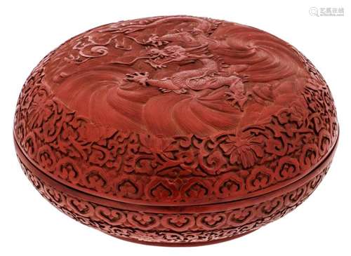 A Chinese red cinnabar floral and dragon decorated lacquer box and cover with a Qianlong mark, H 12,5  - ø 27,5 cm