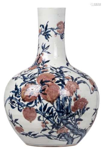 A Chinese copper red and cobalt blue nine peaches decorated bottle vase, with a Qianlong mark, H 56,8 cm