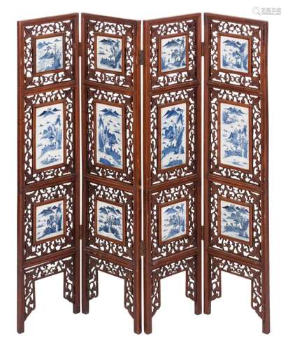 A Chinese four-piece openwork hardwood screen, the porcelain plaques blue and white decorated with figures in mountainous river landscapes, H 132 - W 128 cm