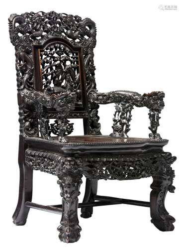 A Chinese richly carved hardwood dragon decorated armchair, the openwork back decorated with an animated scene, H 99 - W 62 - D 57 cm