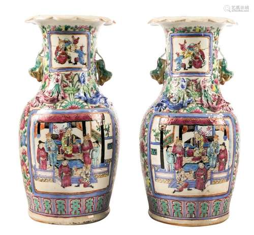 A pair of Chinese famille rose and relief decorated vases, the roundels with court scenes, H 35,5 cm