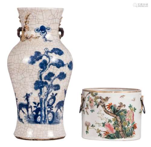 A Chinese stoneware blue and white and relief decorated baluster shaped vase depicting deers and a pine tree, marked, about 1900; added a Chinese famille rose decorated pot with birds and flower branches, marked, H 14 - 36 cm