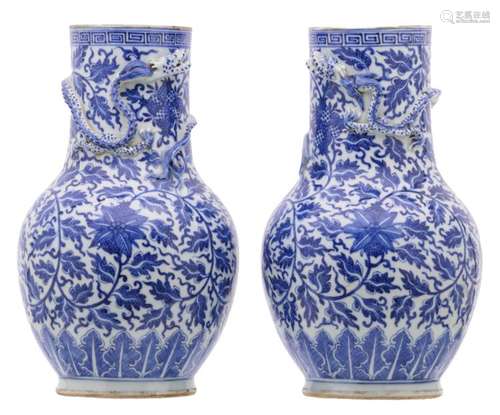 A pair of Chinese blue and white floral and dragon relief decorated vases, with bronze mounts, H 35 cm (without mounts) - 44 cm (with mounts)