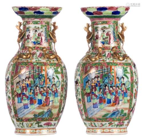 A pair of Chinese famille rose vases, floral and relief decorated, the roundels with court and animated scenes, H 44,5 cm