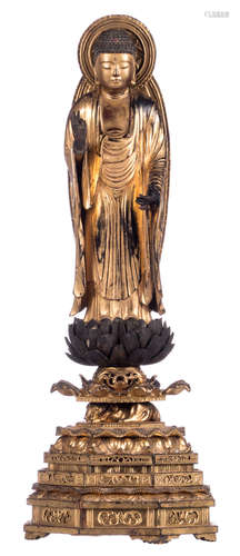 A Japanese gilt lacquered carved standing wooden Buddha on a ditto lotus base, Meiji and period, H 65 cm