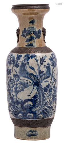 A Chinese blue and white and relief decorated stoneware vase with phoenix on a rock and flower branches, marked, about 1900, H 61,5 cm