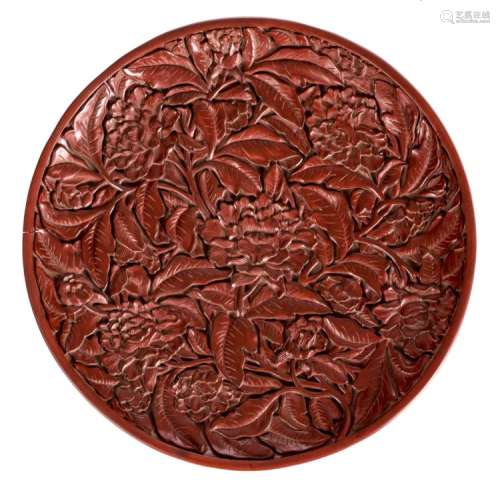 A red cinnabar lacquer plate, carved with chrysanthemum and scrolling foliage, with calligraphic texts, marked, ø 35 cm