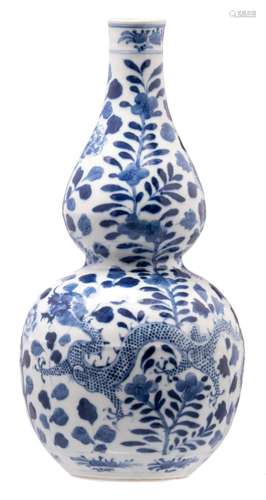 A Chinese blue and white decorated double gourd vase with dragons and flower branches, H 33,5 cm