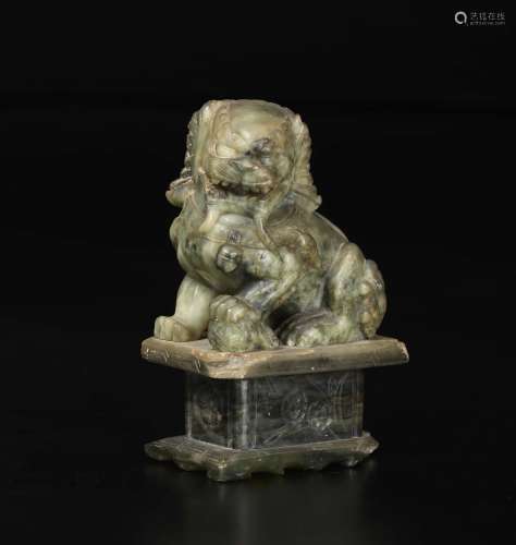 A green and russet jade figure of Pho dog, China, 20th cen ...